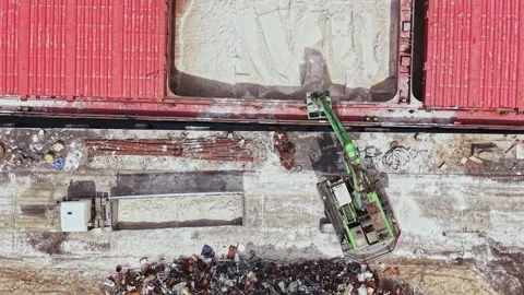 Large machine moves materials at a shipping yard with containers and waste in Stock Footage 337885410