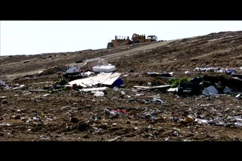 A large machinery moves through a garbage dump. Stock Footage 552354