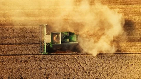 Large Machinery Working a Crop Field Contrast Vivid Colors Steady Follow Top Stock-Footage 289565796