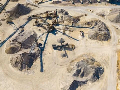 Large machines are digging and transporting sand and gravel at a construction Stock Photos