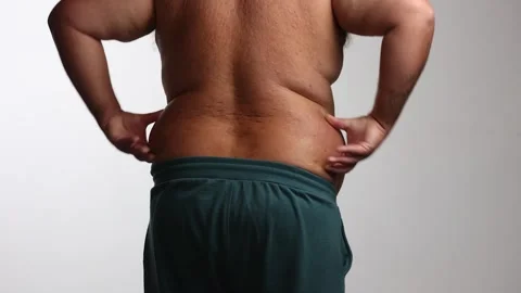 Large man against white background grabs fat love handles and belly Vidéo 310651195