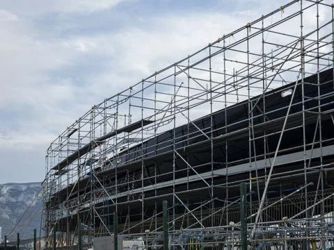 Large marine scaffold structure over vessel at port repair yard with distan.. Stock Photos