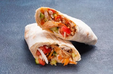Large meat Shawarma in wheat pita bread with chicken fillet Stock Photos