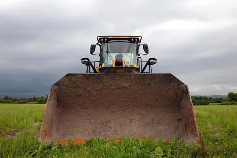 Large mechanical excavator backhoe construction yellow equipment vehicle fr.. Stock Photos