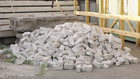 A large messy pile of white bricks on the ground at a construction site Stock Footage 336710806