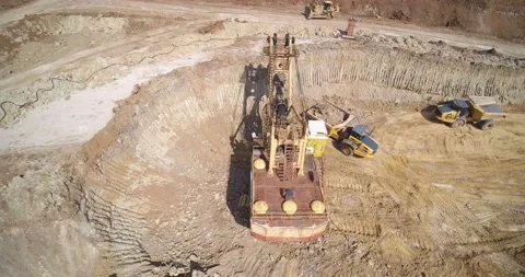 Large metal backhoe loader puts sand on quarry dump truck Stock Footage 131943193