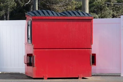 A large, metal, garbage container and municipal waste, standing on a road nea Stock Photos