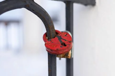 Large metal lock in the shape of a red heart on the fence, horizontal Stock Photos