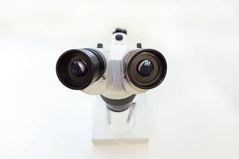 Large metal microscope on a gray background Stock Photos