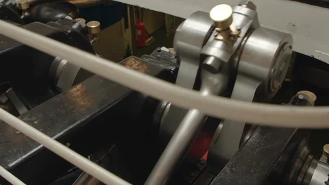 Large metal piston rods and bearings in the crankshaft of an old vintage ship Stock Footage 129044896