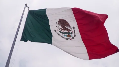 Large mexican flag blowing in the wind zocalo mexico city Stock Footage