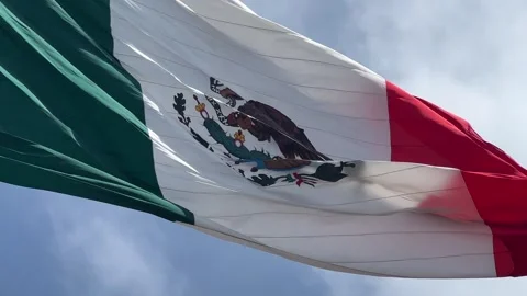 Large Mexican flag waving in the sky Stock Footage 243676368