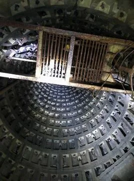 A large mine of a sewer collector that goes up with a rusty ladder Stock Photos