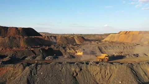 Large mining dump truck driving on a dusty road at the sunset aerial view. Stock Footage 137021609