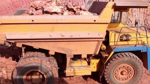 A large mining excavator loads a huge mining dump truck with soil. View from the Video stock 122214569