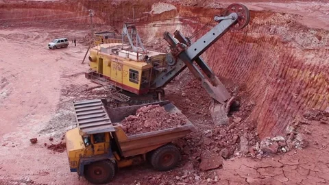 A large mining excavator loads a huge mining truck. Top view, the general plan. Stock Footage 122215588