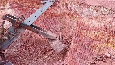 A large mining excavator loads a huge mining truck. Panorama, view from above. Stock Footage 122215613