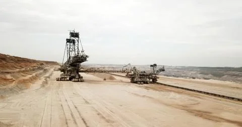 Large mining excavator working on a dirt construction site Stock Photos