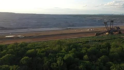 Large mining excavator working on a dirt quarry site Stock Photos