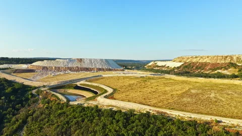 Large mining site with earth moving equipment in the daylight Stock Footage 341029892