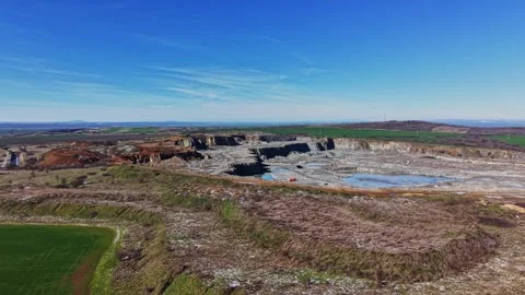 Large mining site in open land with water body during clear weather Stock Footage 337940269