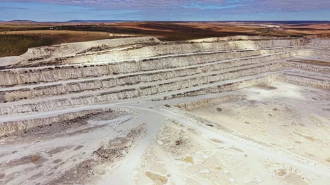 Large mining site showing layered structures and machinery at work in an open Stock Footage 345455411