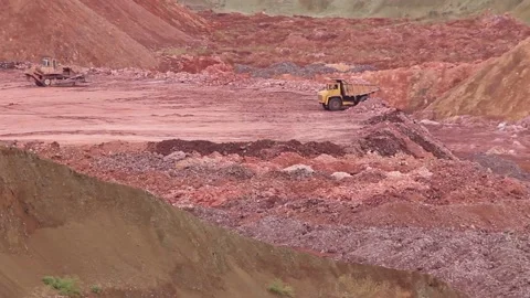 A large mining truck dumps the soil, and a bulldozer levels the soil. Stock Footage 122216494