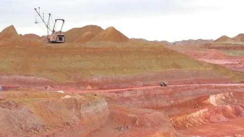 Large mining trucks are moving along the quarry, loaded, empty towards them. Stock Footage 122216296