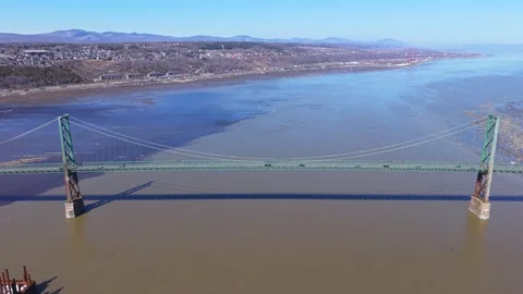 Large modern bridge structure over river aerial canada Stock Footage 333216554