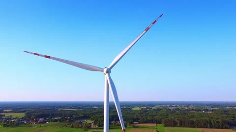 Large modern wind turbine spinning in rural green farmland daytime Video stock 342593092