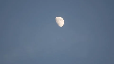 A large moon is in the sky above a blue sky Stock Footage 298246255