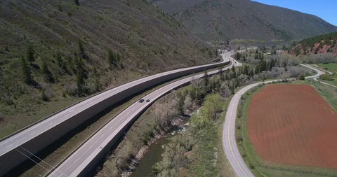 Large mountain highway next to Roaring Fork River near Basalt Colorado Stock Footage 92437583