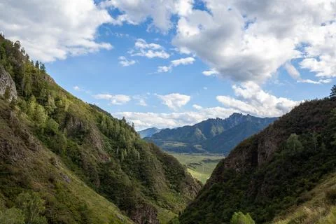 A large mountain with a sheer cliff close-up against the sky. Stock Photos