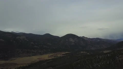 A large mountain sits among other mountains from a drone Stock Footage 167675342