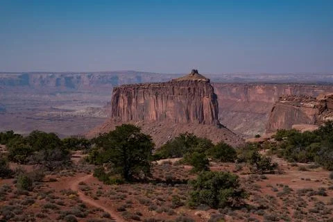 Large mountain standing out between canyons in sunny desert 스톡 사진
