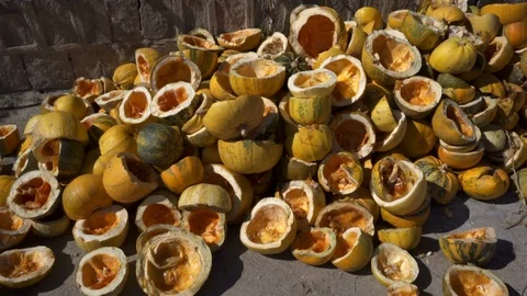 A large mountain of yellow pumpkins, pumpkins are cut into two halves. Stock Footage 117780618
