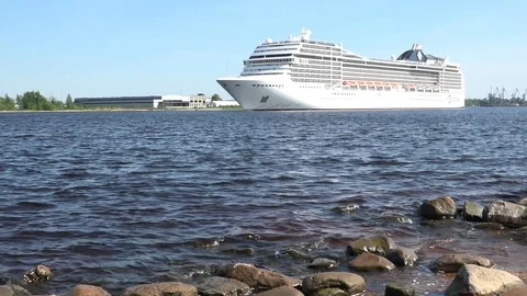 Large MSC Poesia liner sails on Daugava river under blue sky Stock Footage 110845121