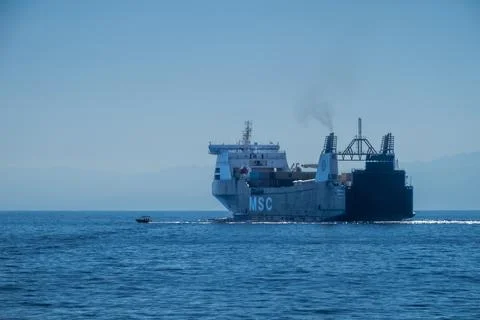 Large MSC roll-on roll-off cargo ship travels across blue Mediterranean Stock Photos