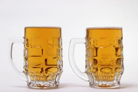 Large mug of light beer on a white background Stock Photos
