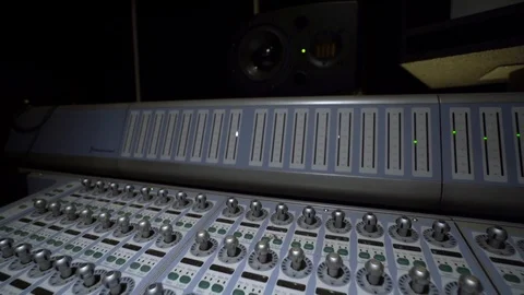 A large multi-channel mixing console in the recording Studio Stock Footage 107193139