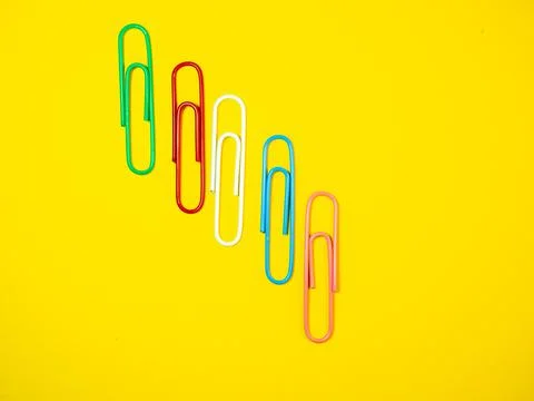 Large multi-colored paper clips. Paperclip of documents.   Bright stationery Stock Photos