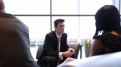 Large multi ethnic business group in relaxed meeting area of a large Stock Footage 32718181