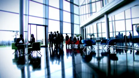 Large multi ethnic business group in relaxed meeting area of a large Stock Footage