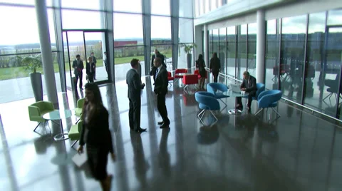 Large multi ethnic business group in relaxed meeting area of a large Stock Footage 32718696