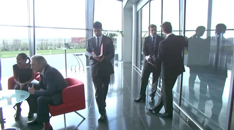 Large multi ethnic business group in relaxed meeting area of a large Stock Footage 32718754