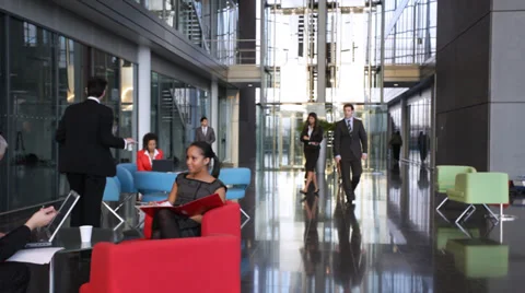 Large multi ethnic business group in relaxed meeting area of a large 스톡 동영상 32719357