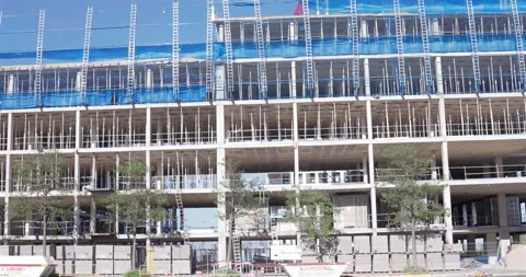 Large multi-storey building under construction with scaffolding structure 스톡 동영상 336301146