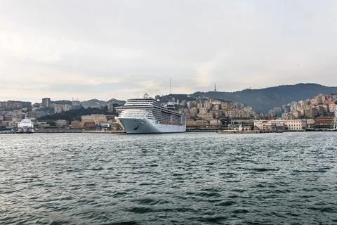 A large multi storey cruise ship stands in the port of genoa in Italy Stock Photos