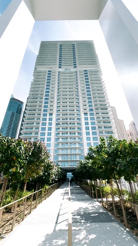 A large multi-storey house surrounded by palm trees near the ocean Stock Footage 263010916