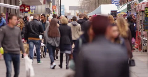 Large multiracial crowd of people walking through busy city shopping area Stock Footage 48112819